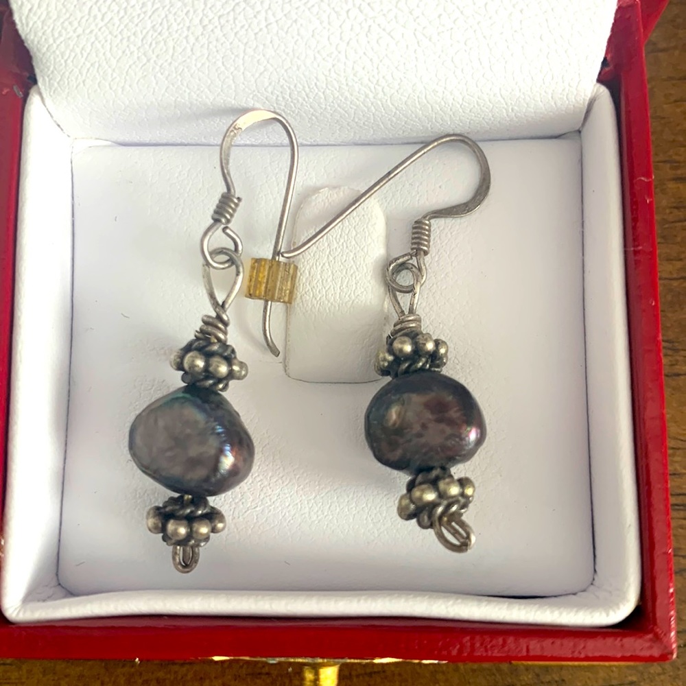 Black pearl earrings with silver detail on top and bottom.